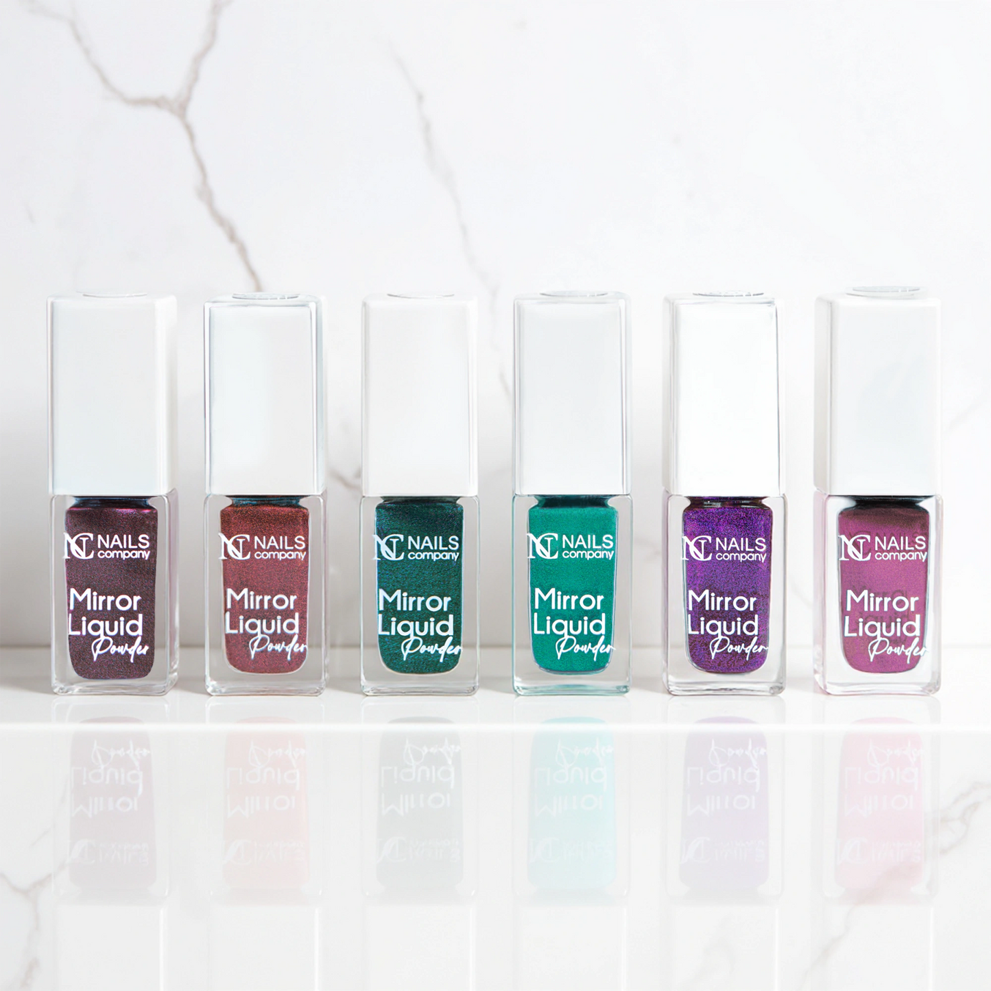 Collection complète Mirror Liquid Powder Nails Company avec six flacons chrome aux différentes couleurs visibles.
