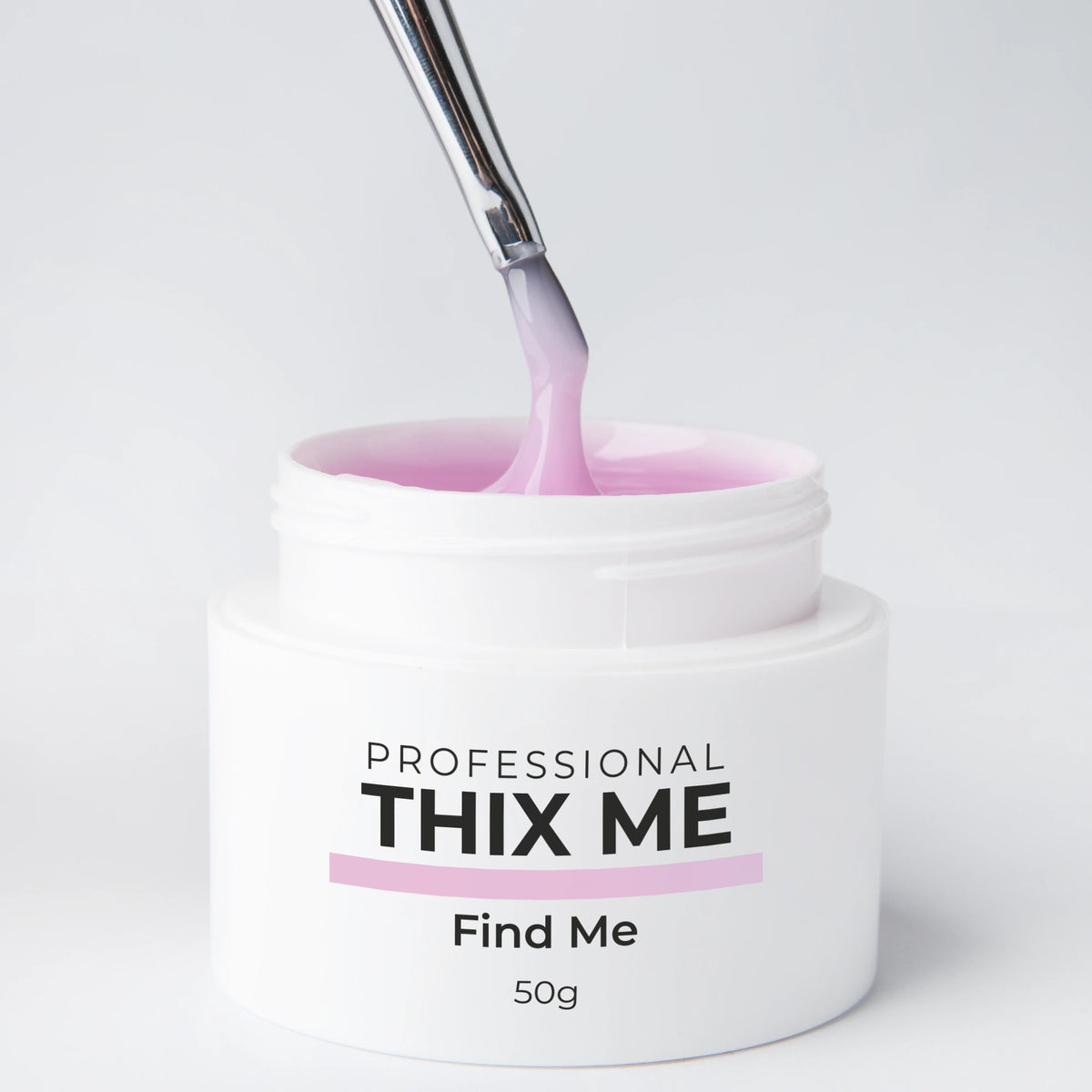 Pot ouvert du gel de construction Thix Me Find Me de Nails Company avec un pinceau tirant la matière