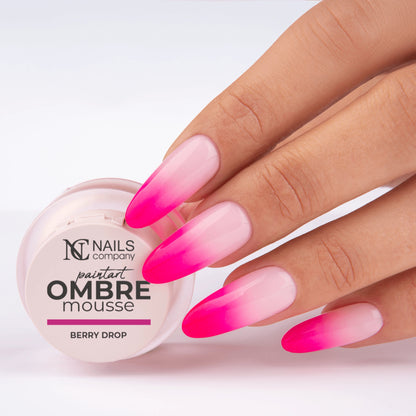 Main tenant le pot de Paintart Ombre Mousse Berry Drop de Nails Company avec le produit appliqué sur les ongles