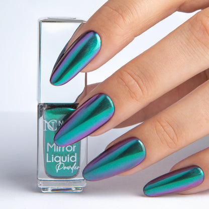 Main tenant le Mirror Liquid Powder 004 Nails Company avec effet chrome émeraude turquoise visible.