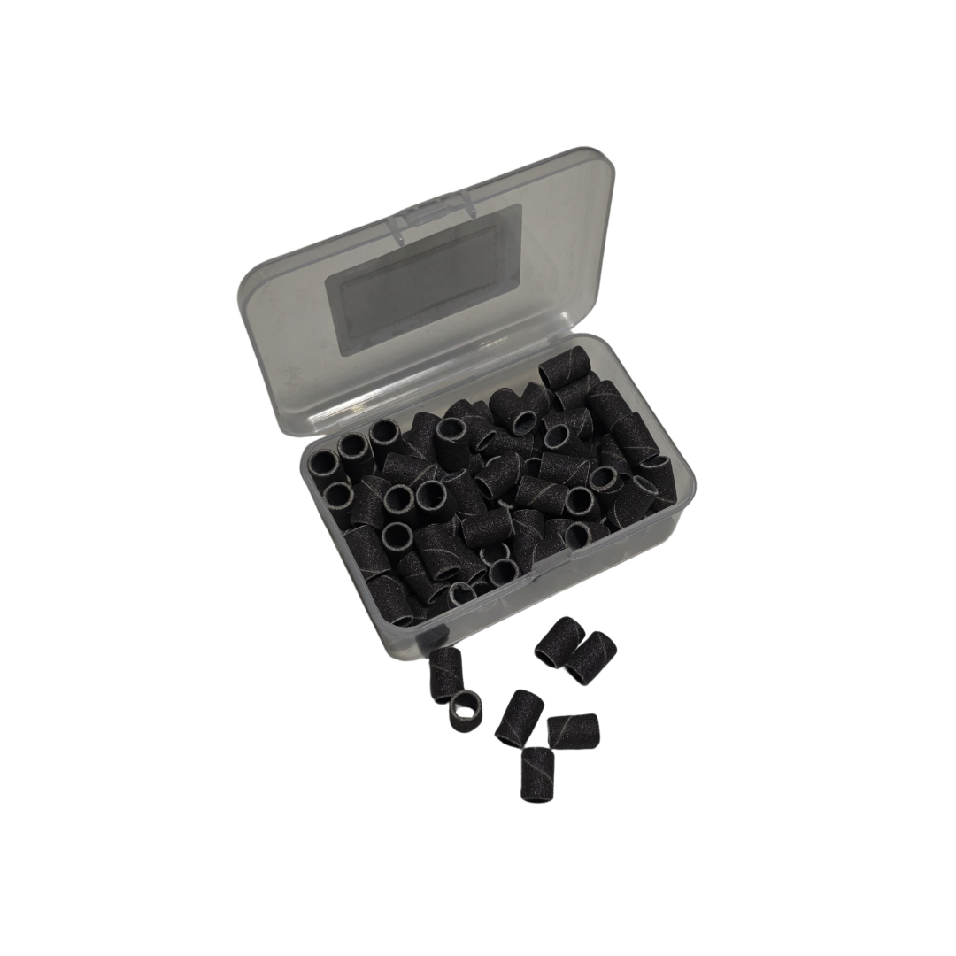 Boite ouverte de recharges Emeris NBT Nails Company avec manchons abrasifs visibles pour ponceuse.