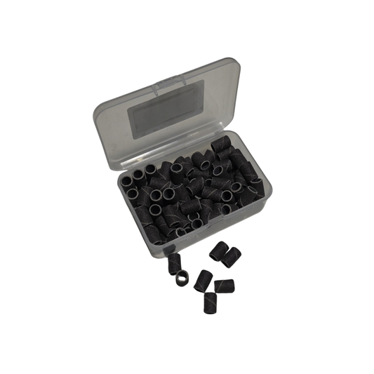 Boite ouverte de recharges Emeris NBT Nails Company avec manchons abrasifs visibles pour ponceuse.