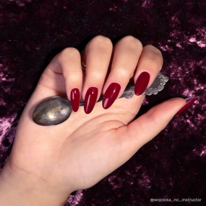 Main avec ongles en vernis semi-permanent Ohh Lord de Nails Company, rouge foncé bordeaux