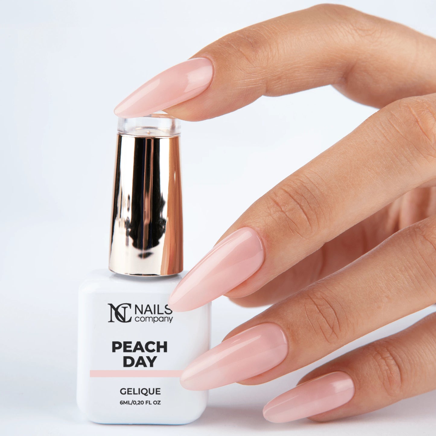 Main tenant le flacon de vernis semi-permanent Peach Day de Nails Company, collection Choose Your Mood